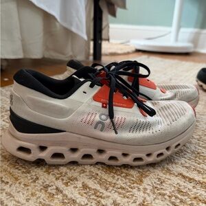 On Running Cream and Black Sneakers with Orange Accents